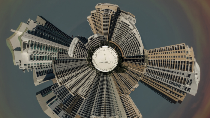 a 360-view of Dubai's high rise building surrounding an Emirati dirham at the center