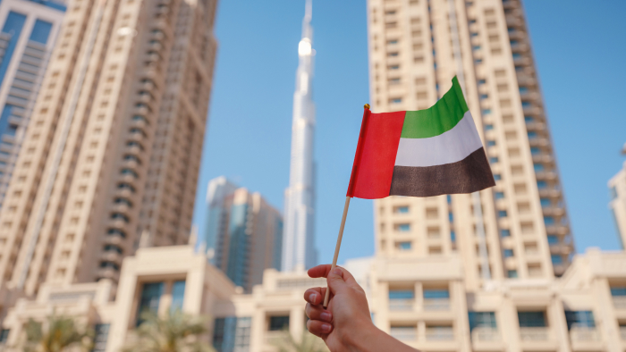 the image illustrates Dubai's famous Burj Khalifa and the flag of the United Arab of Emirates